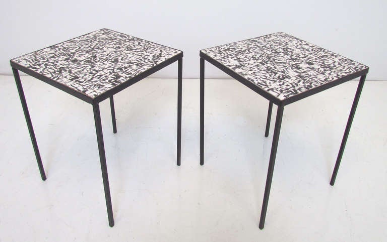 Pair of matching wrought iron side tables, each top with black and white tiles. In the manner of Roger Capron. Likely of Italian origin, imported for Raymor, ca. 1960s.