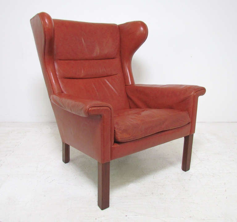 Rare wing back lounge chair in original leather upholstery with flared arms and rosewood legs designed by Hans Wegner for A.P. Stolen ca. mid-1960s.  Signed with Danish control tag.