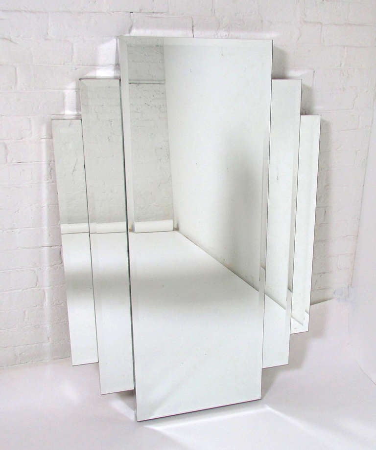 Rare large Wall Mirror by Hal Bienenfeld, ca. 1970s (signed).  Beveled edges and fully mirrored sides, central mirror flanked by stepped side panels.  Unlike his more common op-art creations, this extremely high quality mirror offers a more