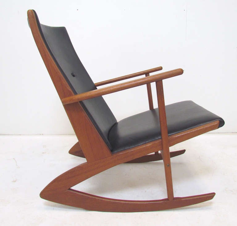 Danish Modern sculptural teak rocking chair designed by Soren Georg Jensen, manufactured by Kubus, Denmark, ca. early 1960s.  Upholstered in soft glove leather.