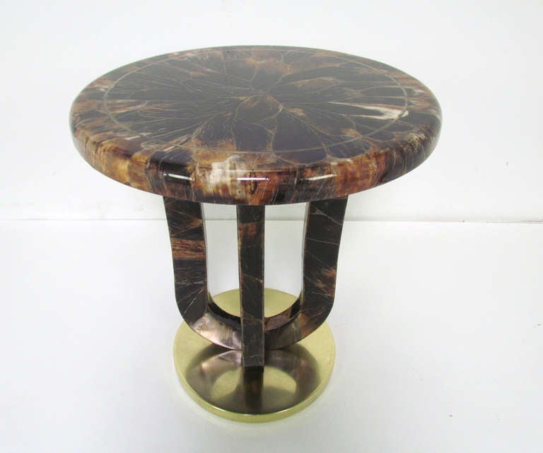 Spectacular art deco inspired occasional side or cocktail table in tortoise shell-like horn with brass accent and base by Enrique Garcel (signed), ca. 1980s.  The horn is intricately inlaid in a petaled floral pattern.   

Like Karl Springer,