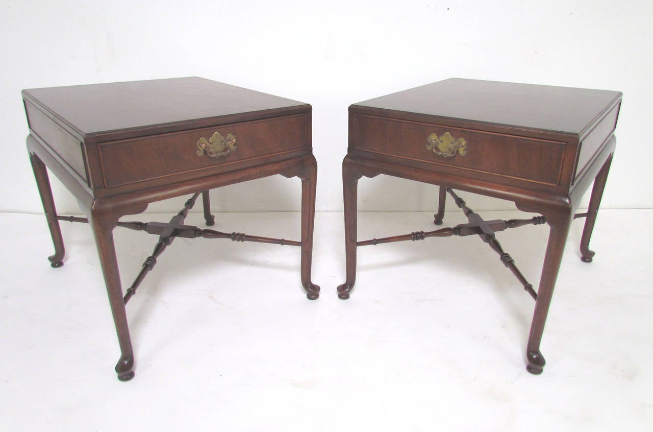 Pair of Georgian style Mid-Century end tables by Heritage Furniture, Signers Collection, date stamped 1965. Slender cabriole legs, cross form stretchers, and solid brass hardware. Fine level of craftsmanship rarely seen in most reproductions of