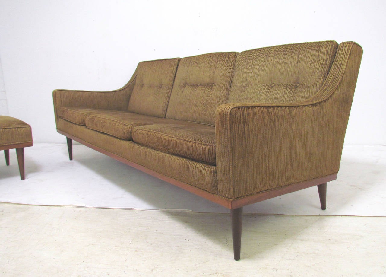 Mid-century sofa, early design by Milo Baughman for James Inc. Articulate Seating, with a matching Articulate ottoman (bearing early Thayer Coggin tag (James Manufacturing was founded by Thayer Coggin and later the company bore his name).  

Sofa