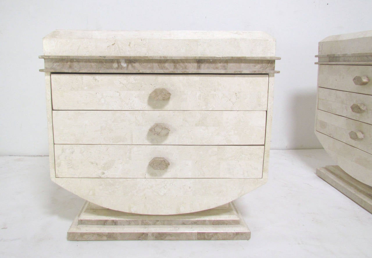 Pair of end tables or nightstands by Robert Marcius for Casa Bique in tessellated fossil stone, each with beveled bottom supported by pillars on a flat plinth, circa 1970s. Each also feature three drawers and have finished backs, so they can float