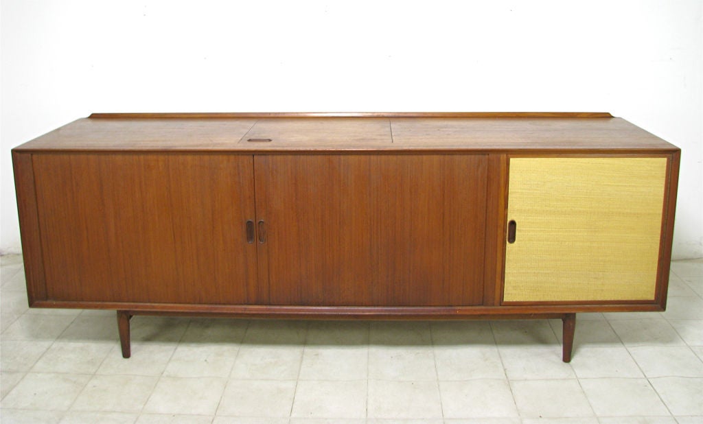 Rare Danish Modern teak console sideboard designed by Arne Vodder for Sibast, ca. early 1960s. Fitted as a hi-fi stereo cabinet.  Top features drop-in element to accommodate turntable. Tambour doors reveal shelving for components, some records too.