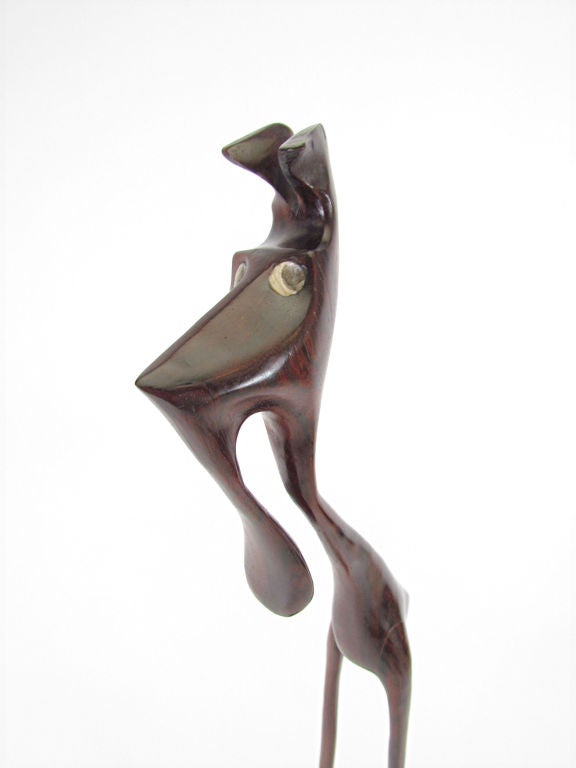 Danish Modern abstract sculpture of an intriguing creature in hand carved rosewood signed Knud Albert, ca. 1960s.  Made in Denmark. Measures  22 3/4