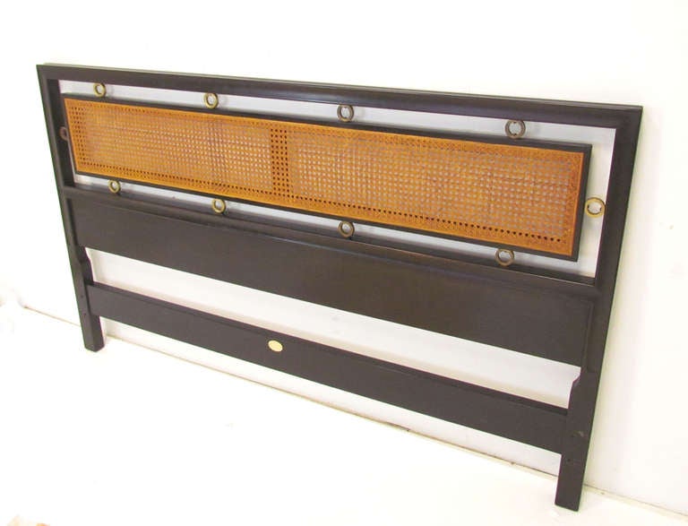 Mid-century headboard for a queen size bed in cane and ebonized wood with brass ring accents by Michael Taylor for Baker Furniture, ca. 1950s.