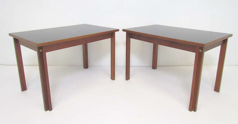 Rare pair of side tables designed by Borge Mogensen for Fredericia, Denmark, in 1958, this model with teak framework and gloss black laminate inset tops.   Exposed brass corner nut.