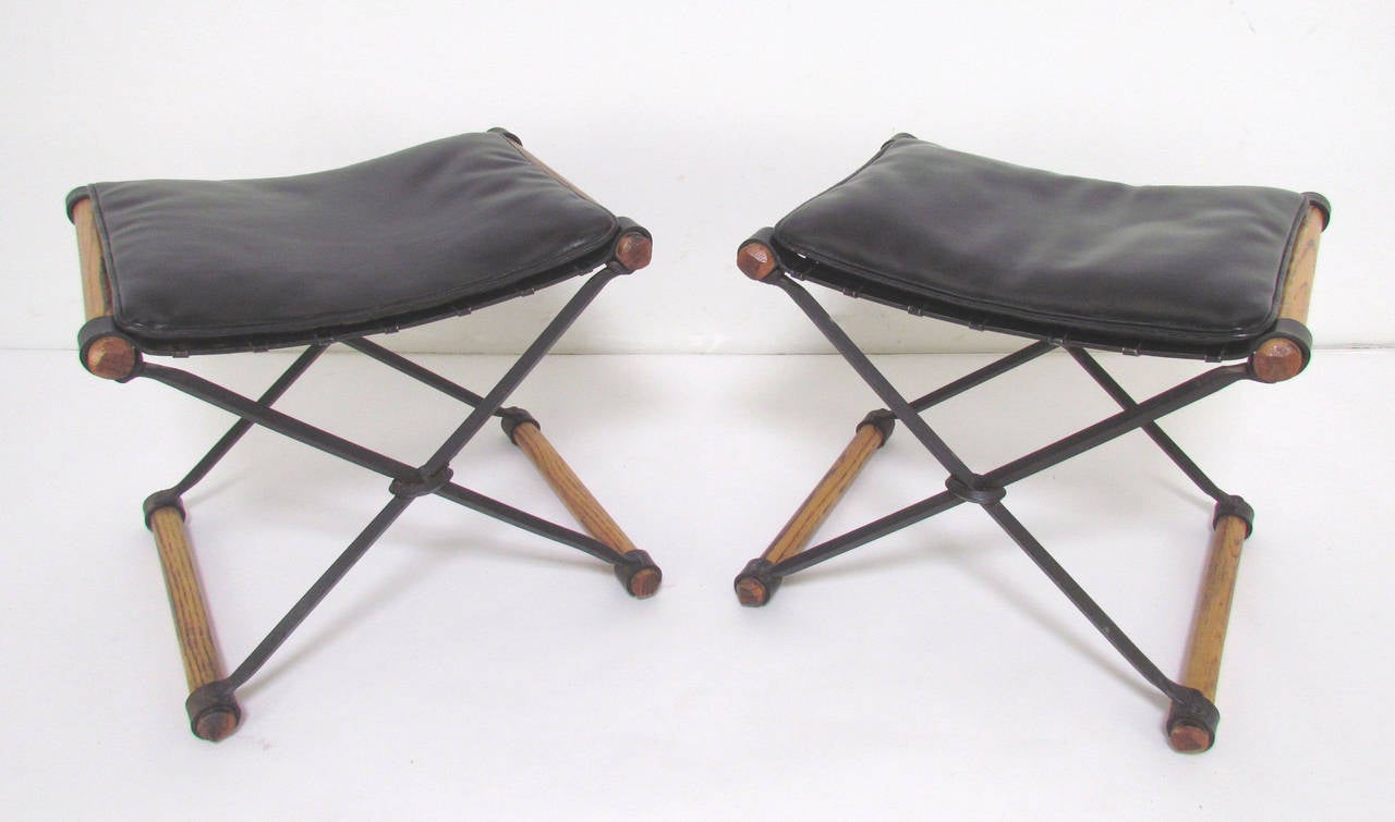Pair of X-form stools by Cleo Baldon for Terra Furniture in iron and oak with original leatherette cushions, circa 1960s.