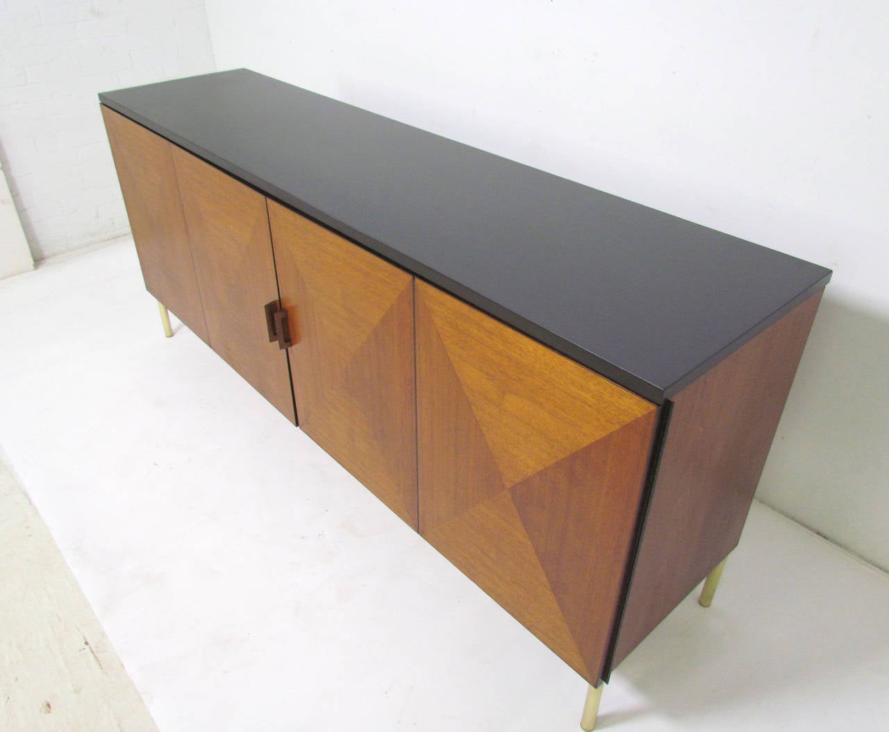 Rare credenza by Calvin for Directional furniture. The cabinet features a polished slate top and diamond pattern bi-fold doors and interior drawers finished with recessed lacquered pulls. Although we have been unable to definitively document this