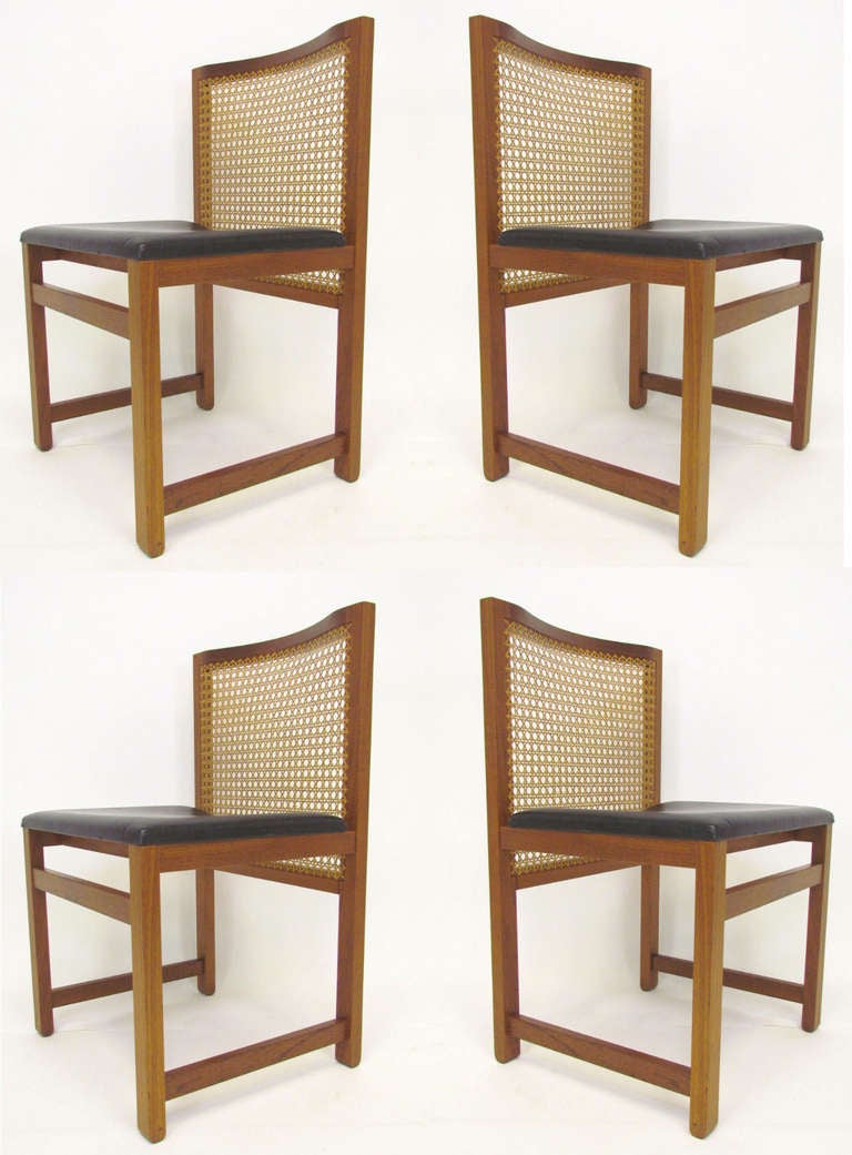 Set of four dining chairs in teak and cane designed by Knud Andersen for J.C.A. Jensen.      Hand pegged cane bakcs, and unusual rounded feet detail.   A superbly crafted and formative design, these chairs, date stamped June 1970, highly reflect the