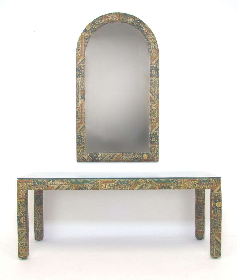 Custom made parsons console table and matching arched mirror, both upholstered in their original Indian printed chintz fabric, ca. 1970s.

Console measures 60