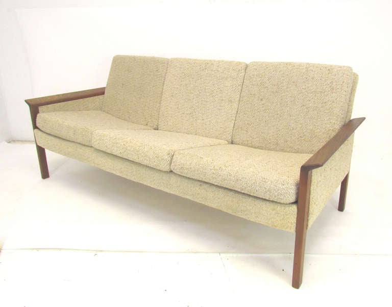 Mid-century modern sofa with sculptural teak arms by Hans Olsen for CS Mobler, ca. 1960s.  Teak frame is in fine condition, but requires re-upholstery.