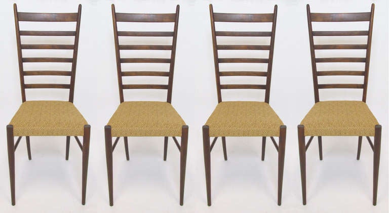 Set of four graceful dining chairs with graduated ladder backs in the style of Gio Ponti, one retains remnants of a made in Italy label.    Clean upholstery.   Ca. 1950s.