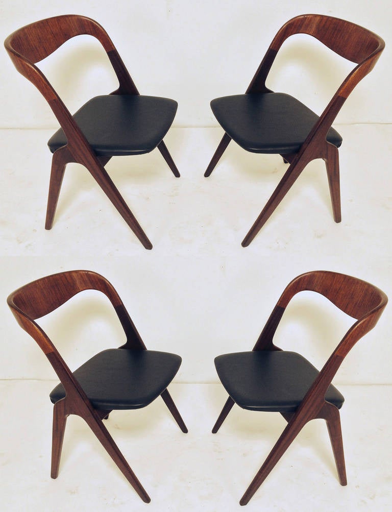 Set of four Danish teak dining chairs with sculptural carved backs, by Vamo Sonderberg, ca. 1960s.    Scooped back and transverse leg similar in style to designs by Kai Kristiansen.