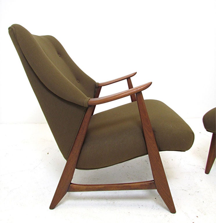 Pair of upholstered Danish lounge chairs with sculptural winged backs and teak frames, ca. 1950s or 1960s.