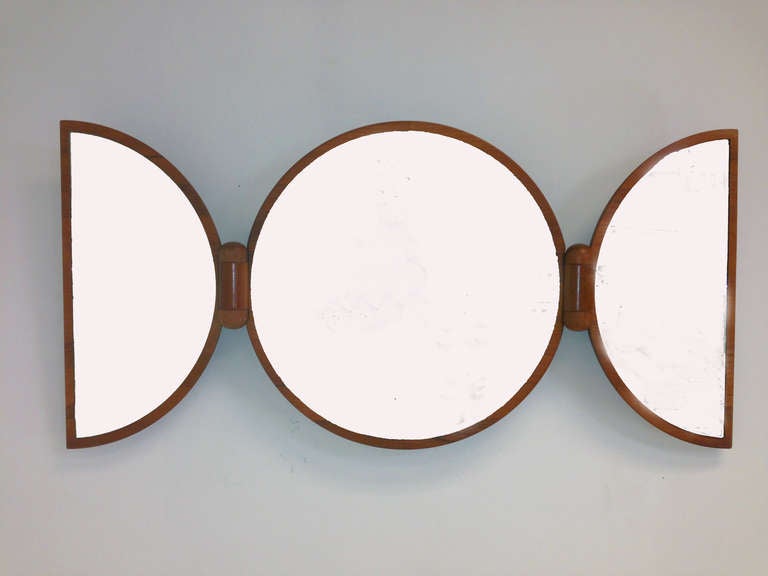 Danish teak adjustable tri-fold wall mirror with hinged side panels.  When closed, this makes an interesting wall sculpture.   Ca. 1970s.  Attributed to Pedersen & Hansen, Denmark.

Center mirror is 19.5