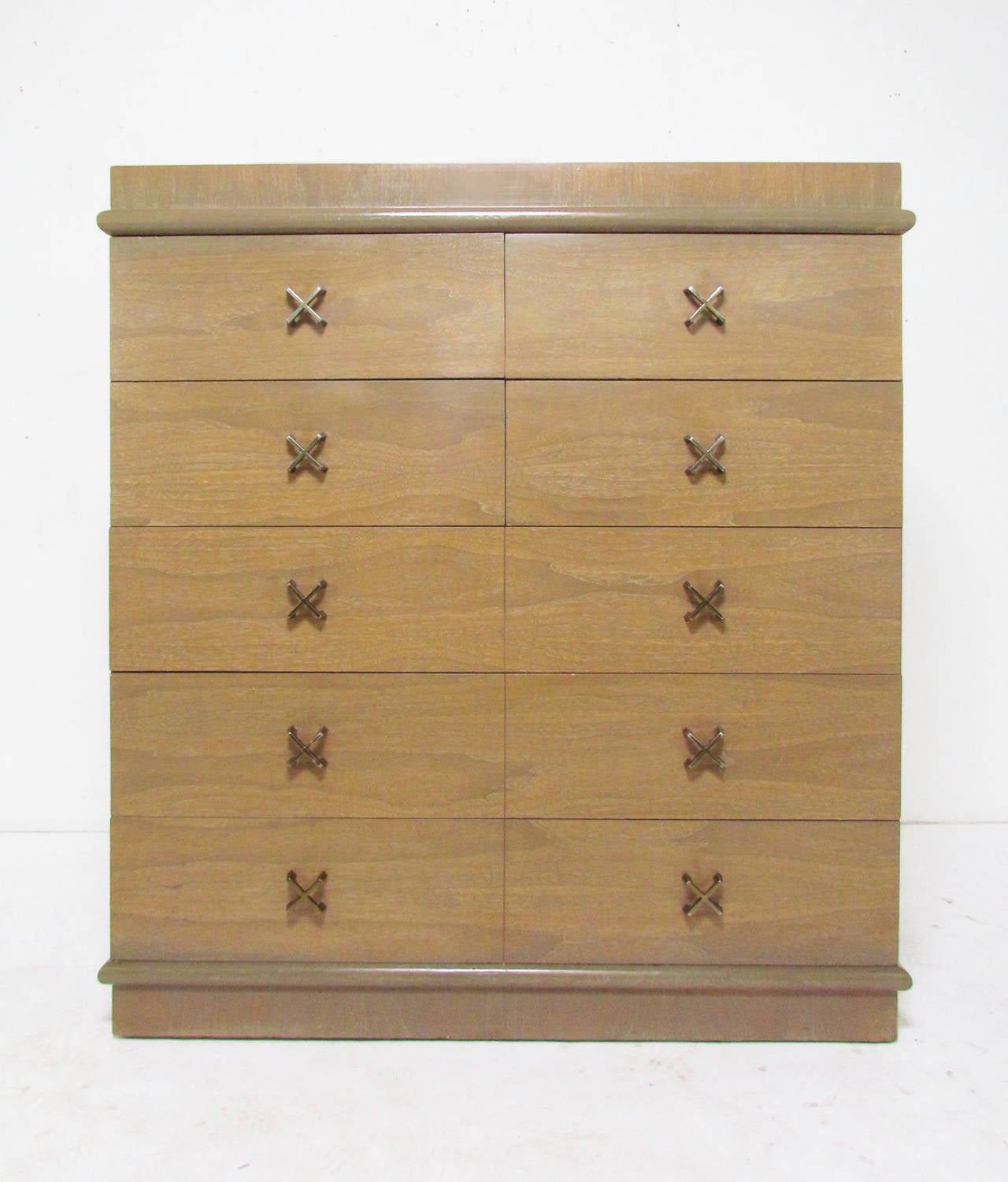 High boy chest of drawers with brass "X" form pulls in the manner of Paul Frankl.