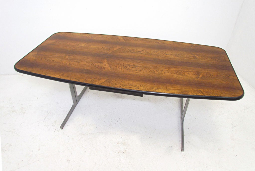 Action Office series conference desk in rare rosewood, designed by Robert Propst of George Nelson Associates, for Herman Miller.    Rectangular top is slightly elliptical, with rounded corners.   Single center shallow drawer for pens, paperclips