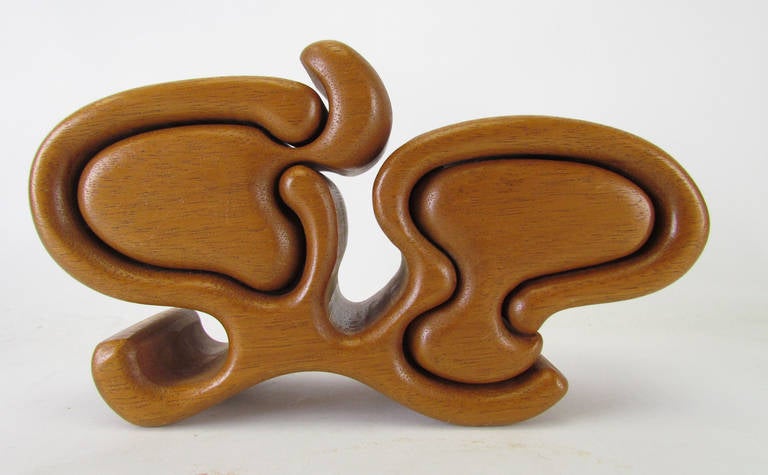 Hand crafted abstract sculptural puzzle box in teak by noted American woodworker Richard Rothbard, an early example made in his Sugarloaf studios, ca. 1970s. Two small compartments can hold rings or other trinkets.