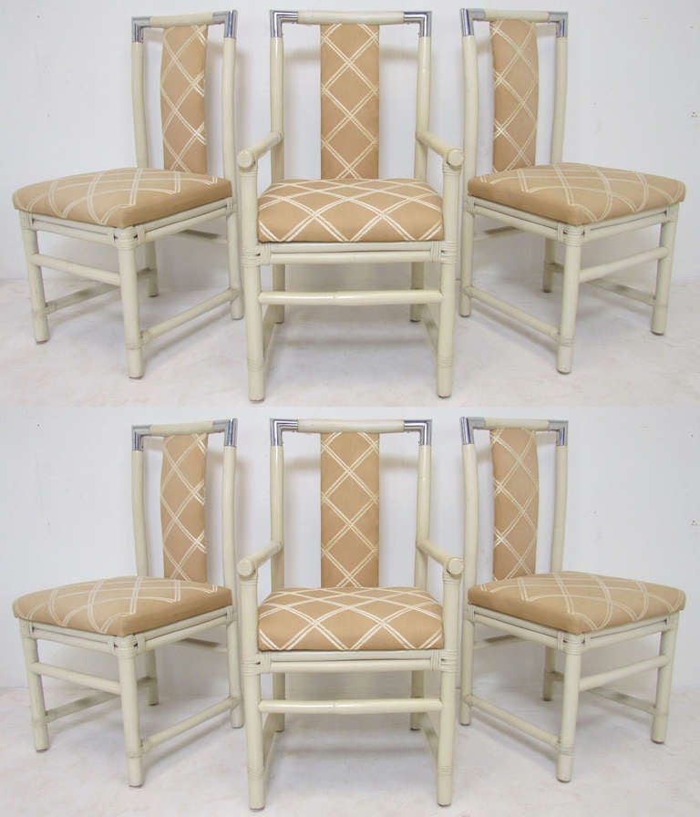 Set of six real bamboo dining chairs  in antiqued white lacquer with unique chrome cornered backs, ca. 1970s.   Original upholstery in good condition with some discoloration, buyer may prefer to recover.

Arm chairs measure 39