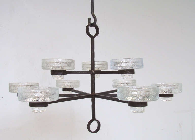 Nine arm candelabrum chandelier by Erik Hoglund, ca. 1960s. Glass candle cups designed to fit three different candle sizes. Includes two length extenders.   Marked 