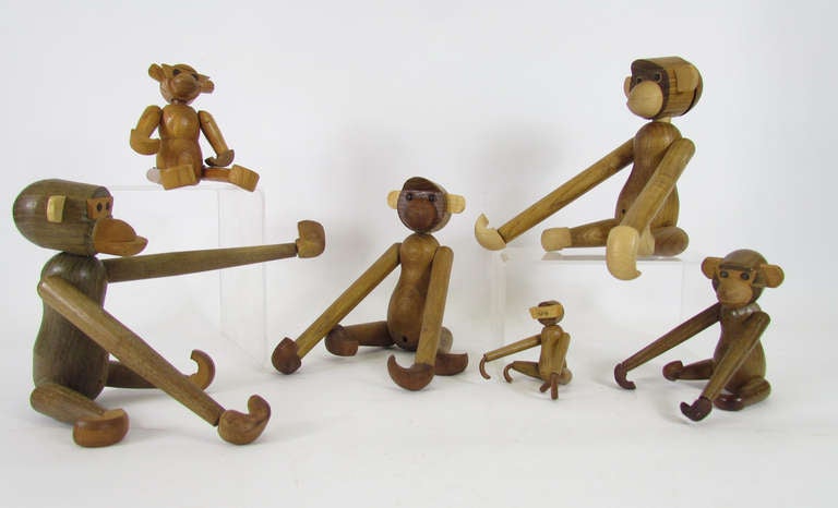 A grouping of mid-century modern jointed teak monkey toys in various sizes, period adaptations inspired by the iconic Danish design by Kay Bojesen.

Smallest measures 3
