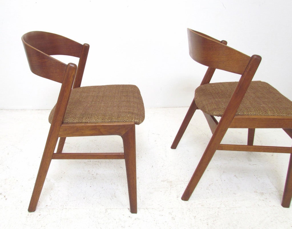 Set of four teak dining chairs with extremely comfortable curved teak seat backs, by Dux, Sweden.