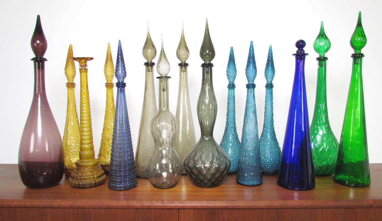 Collection of 15 Mid-Century Modern glass bottle decanters, circa 1960s.

Most unmarked, most likely made in United States (one marked Italy).

Range in size from 19.5
