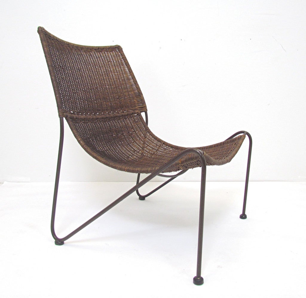 Pair of mid-century lounge chairs in wicker and enameled steel, in the manner of Hendrick Van Keppel and Taylor Green.   We have also seen these attributed to Frederic Weinberg.     Based on the other items in the estate, we date these to the 1960s.