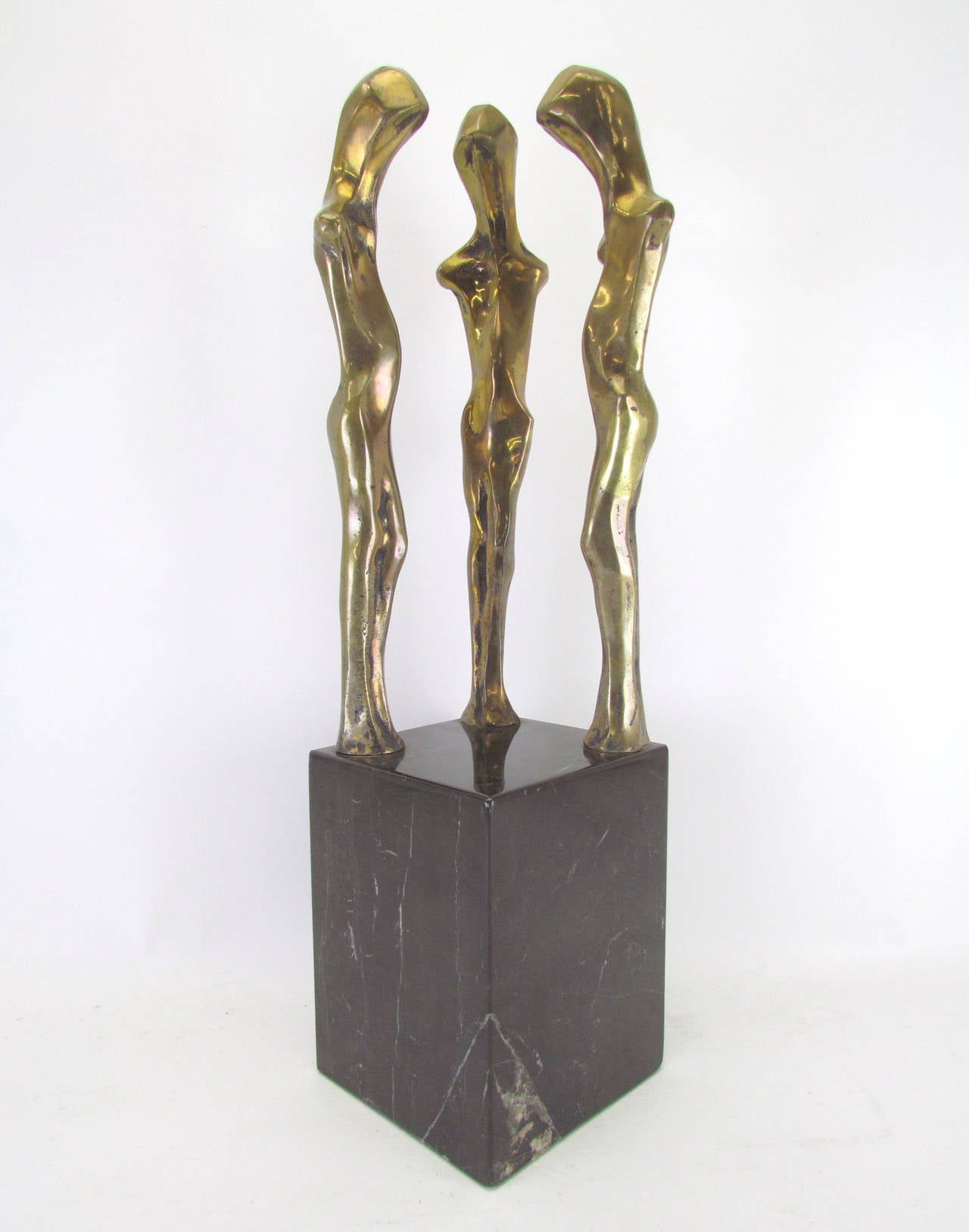 Modernist sculpture of three abstract standing figures in bronze, affixed to a marble base. Signed Davidson.

Measures: 19