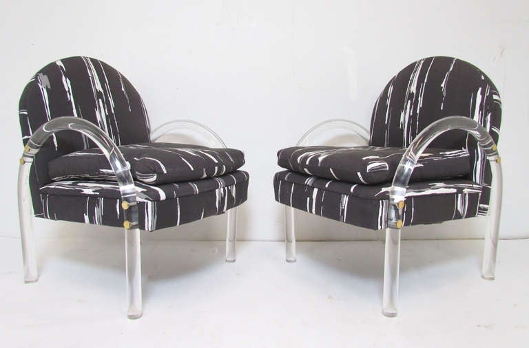 Pair of lucite lounge chairs, designed by Brian Reale for Pace Collection, circa mid 1970's.  Classic low slung form in original screen printed cotton upholstery.