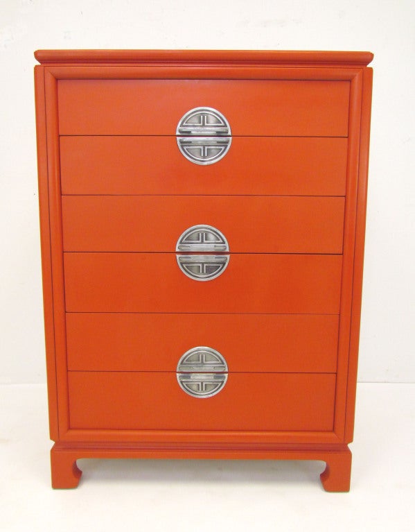 Hollywood Regency highboy chest of six drawers with medallion form pewter pulls.  American made, ca. 1940s, in the manner of James Mont.  Strikingly lacquered in cinnabar red.