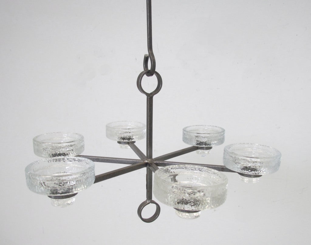 Six arm candelabrum chandelier by Erik Hoglund, ca. 1960s. Glass candle cups designed to fit three different candle sizes. Includes original hanging hook plus one length extender.