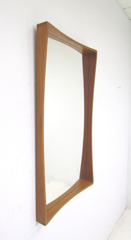 Modernist teak wall mirror by Pedersen and Hansen, ca. 1960s. Attractive exposed finger joints, arched carved framing. Made in Denmark.