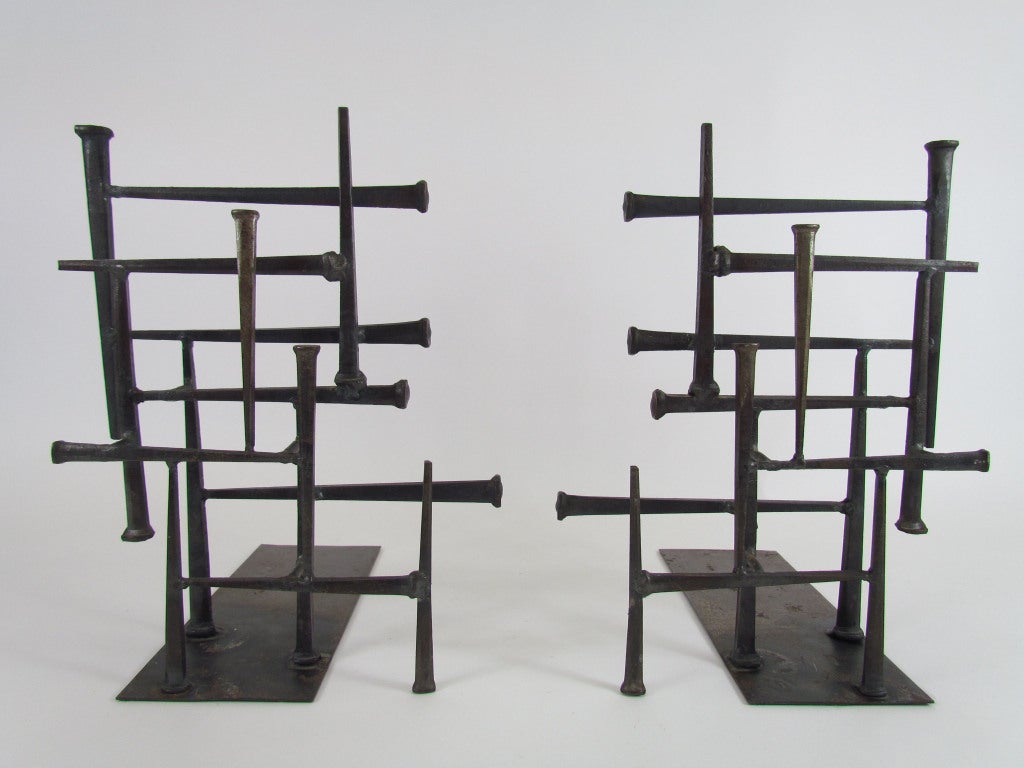 Pair of mid-century modern abstract multidimensional bookends that could just as easily serve as sculpture, constructed with brazed masonry nails arranged in geometrical fashion, ca. 1960s.  Each bookend signed with conjoined 