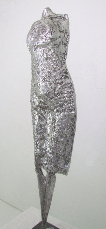 Free form sculpture of a female figure in cast aluminum, with a marble base, ca. 1970s.  Artist unknown.