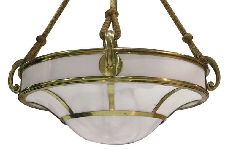 Unique set of two very large pendant lights securely hung by thick rope and fully framed in brass. There are two pairs of these lighting fixtures and all four can be sold together as a group. 

*Not available for sale or to ship in the state of