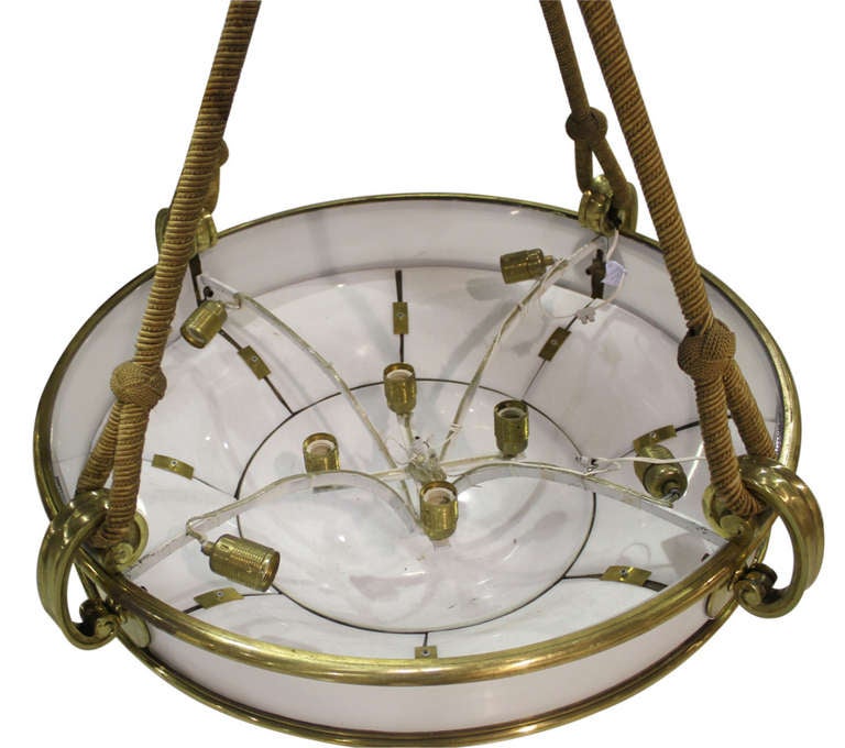 Unique set of four very large pendant lights securely hung by thick rope and fully framed in brass.

Not available for sale or to ship in the state of California.