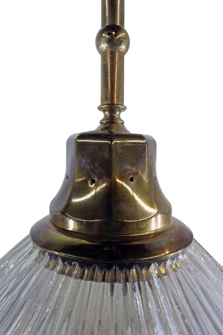 Brass canopies, tubing and pendant caps have desirable aged patina. The pendant glass on both pieces is in excellent condition. Each fixture accommodates two light bulbs. 

Not available for sale or to ship in the state of California.