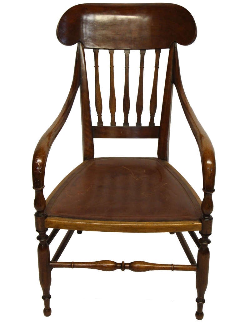 Regency style arm chair with beautifully crafted spindle legs and stretcher. Deep seated chair detailed with a perfectly weathered inlaid leather seat. 

*Not available for sale or to ship in the state of California.