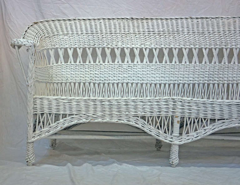 Painted white wicker bench with excellent detailing throughout. Wooden wicker base and previously green painted color comes through in places adding to the character and aged charm. 

*Not available for sale or to ship in the state of California.