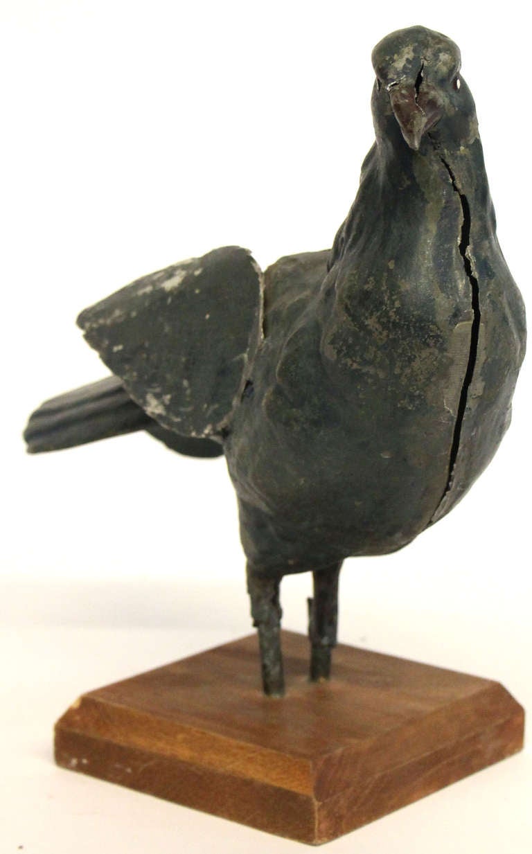 Folk art bird sculpture. Metal body and wings on a beveled wooden  plaque. 

*Not available for sale or to ship in the state of California.