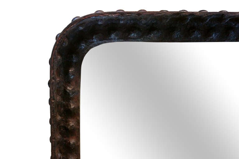 Very heavy mirror with iron frame and bolted detail. Minor patina throughout on mirror surface. Additional photos available upon request.

Not available for sale or to ship in the state of California.