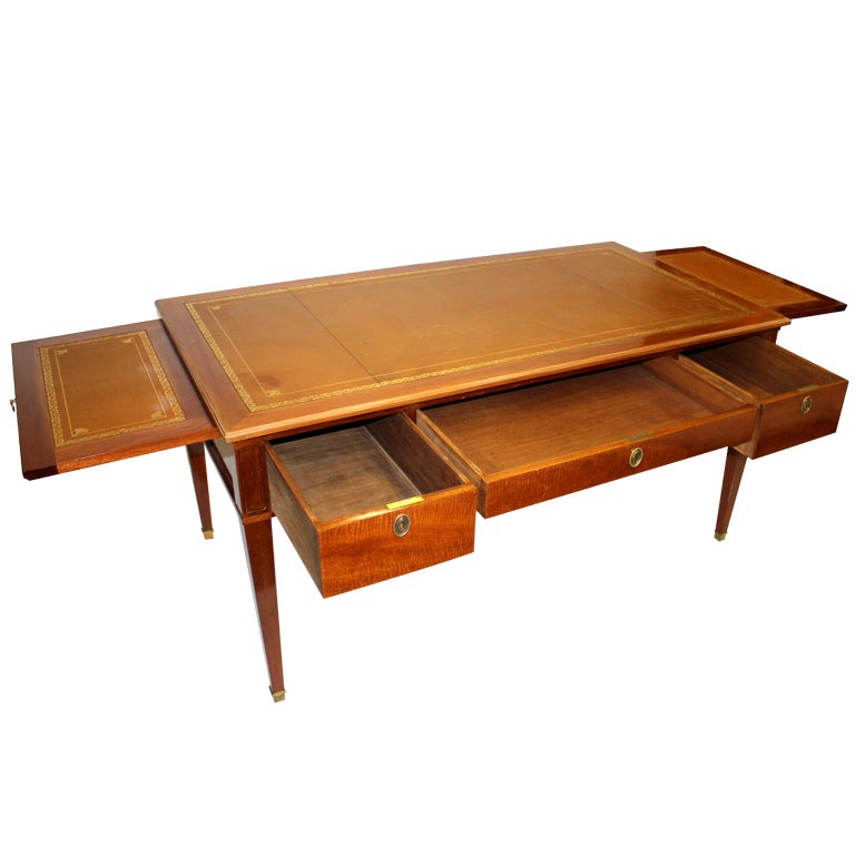 Figured mahogany trim, skirt and legs capped in brass. Three drawers, embossed leather detail top with side pulls extending table length.

Not available for sale or to ship in the state of California.