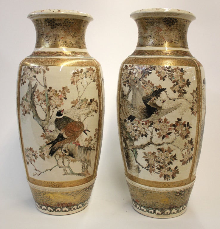 Pair of Japanese Satsuma vases with three different decorative panels - each displaying various birds. Raised beaded trim surrounding the neck of the vases and raised dividers between each panel.

*Not available for sale or to ship in the state of