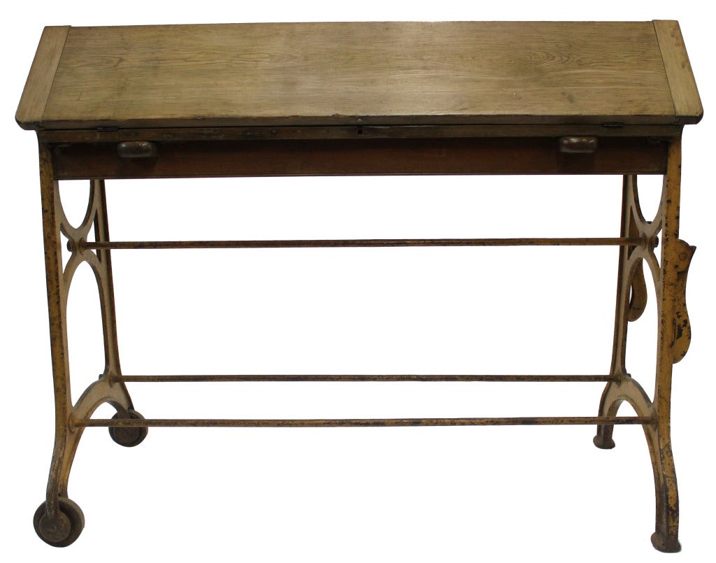 Industrial work bench covered in a beautiful yellow patina. Wood bench top folds and expands easily with additional support for either side. Very mobile due to the wheels on one side of bench (as seen in image 4) and handles on the other side (as