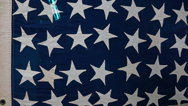 Original American flag with 35 whimsical stars and exaggerated features. The elongated format is the specified size of a US Army Civil War recruiting flag. The canton is pieced in two sections, due to the fact that wool bunting was only available in