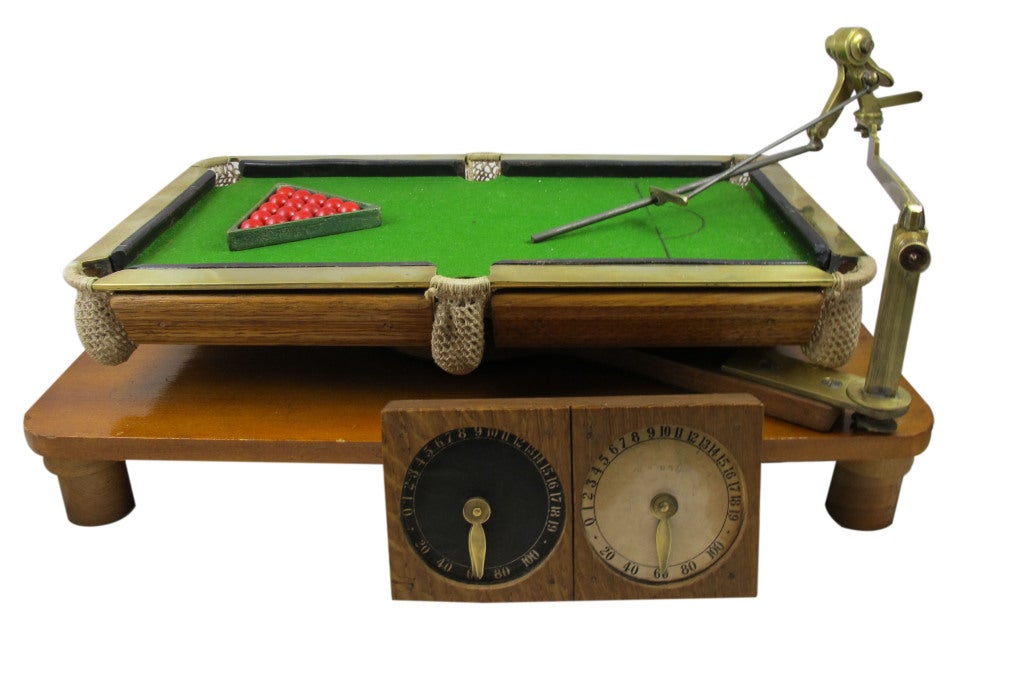Antique model of a pool table, complete with score keeper, cue, and balls, English, circa 1900. Please note, cue can be
unscrewed for easy shipment.