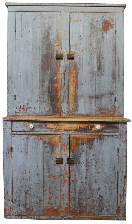 Primitive step back cupboard in weathered green patina. Three shelves on top, functional drawer and matching, with top, two-door bottom.